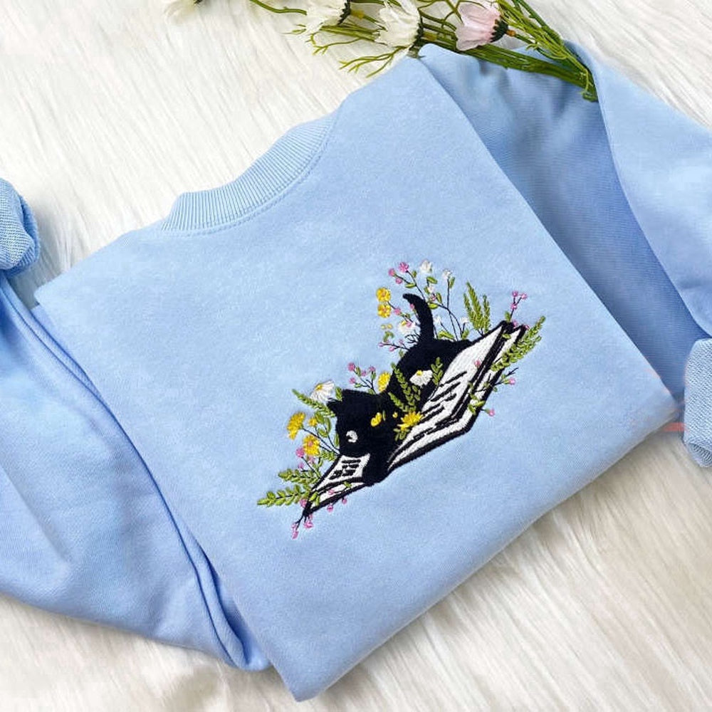 Eembroidered Custom Sweatshirts, Cute Cat Lying On Book With Flower Embroidered Sweatshirt Gift For Christmas, Christmas Gift