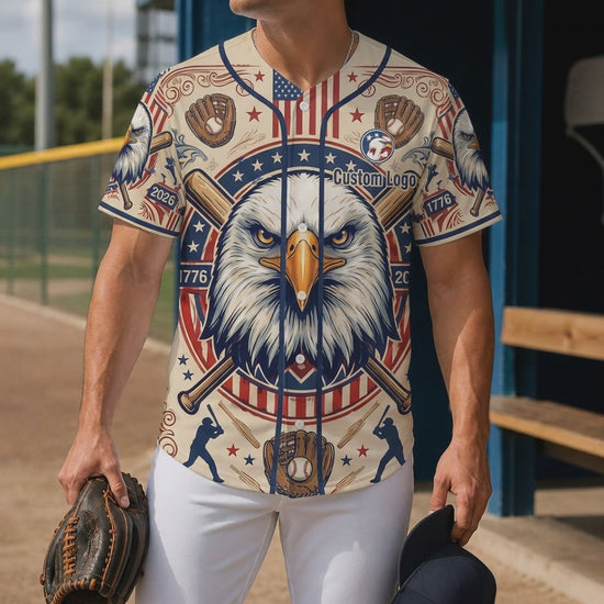 A man wearing a heritage eagle baseball jersey on a sports field, showcasing the vintage eagle and baseball design
