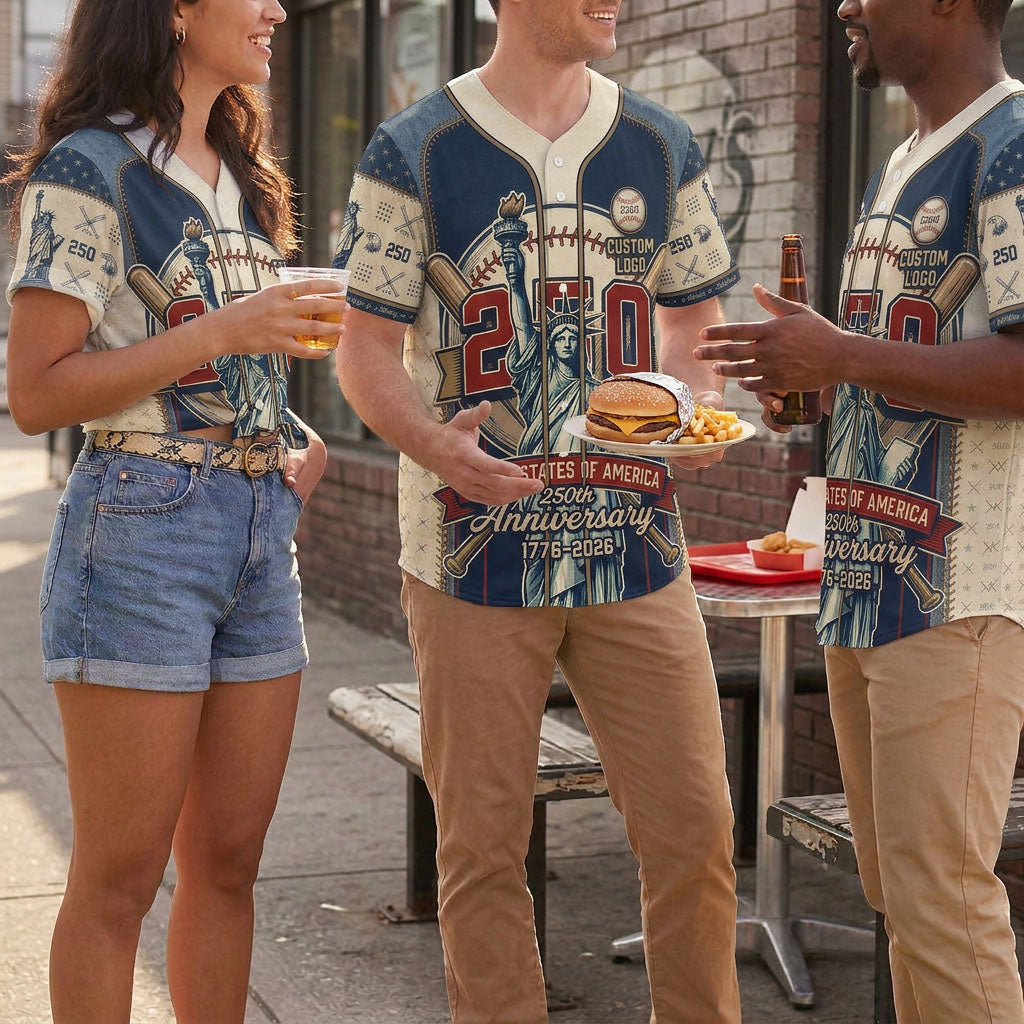 A diverse group of friends chatting outdoors and enjoying lunch while wearing matching textured Statue of Liberty USA 250th anniversary jerseys.