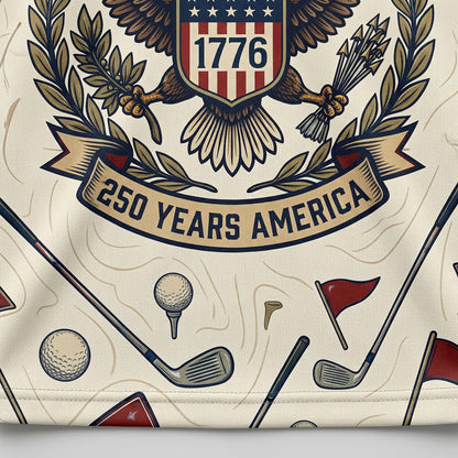 Close up detail of the golf polo highlighting the 1776 shield eagle crest, 13 stars, and classic line-art golf graphics.
