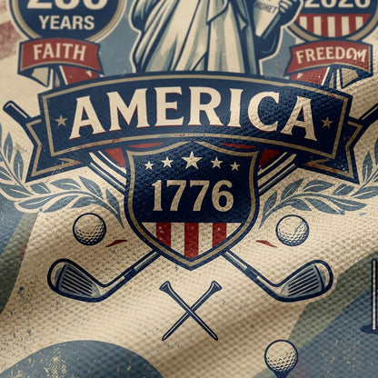 Close up detail of the golf polo displaying the high-definition Statue of Liberty emblem, America 1776 crest, and golf green elements.