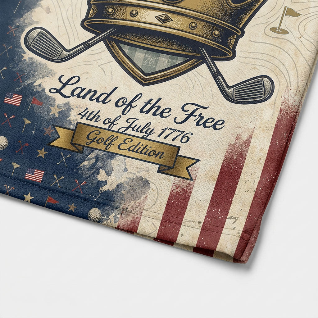 Close-up shot of the high-definition printed golden crown emblem, crossed golf clubs, and Land of the Free text on a premium polo shirt.