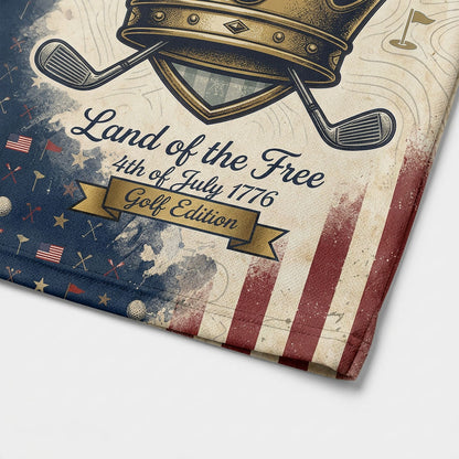Close-up shot of the high-definition printed golden crown emblem, crossed golf clubs, and Land of the Free text on a premium polo shirt.