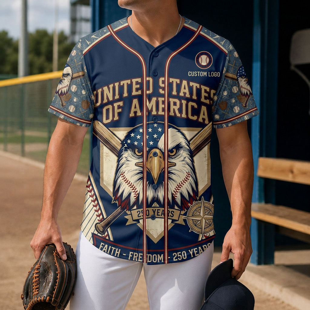A male model wearing the custom USA Faith Freedom 250 Years baseball jersey at a baseball field dugout while holding a leather mitt.