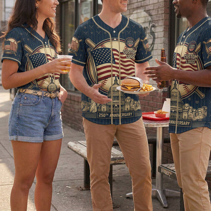 A group of friends wearing matching navy blue USA Landmark baseball jerseys laughing and sharing a meal outdoors.