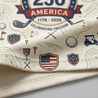 Close up detail of the golf polo hem showing the line-art golf pattern, patriotic shields, and crisp fabric weave.